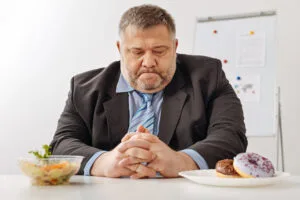 Uncertain obese man facing a hard choice