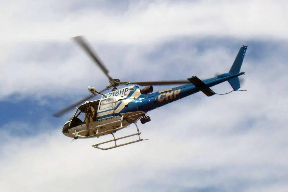 A CHP Helicopter flying with number N216HP along the side.