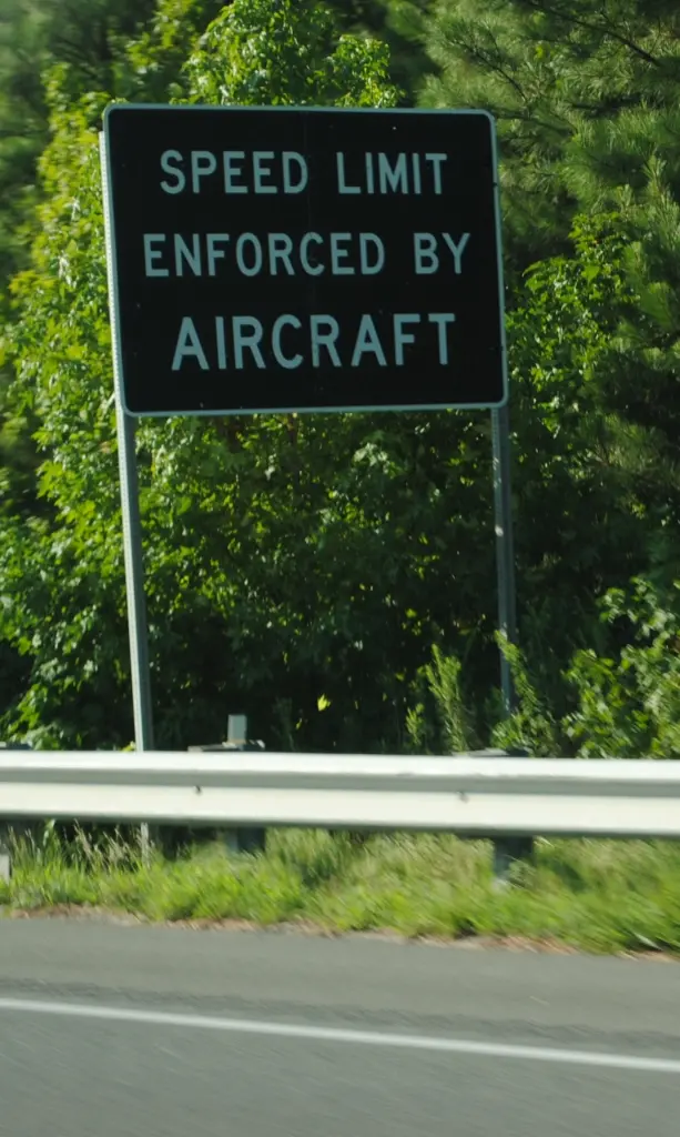 Speed enforced by aircraft sign along road