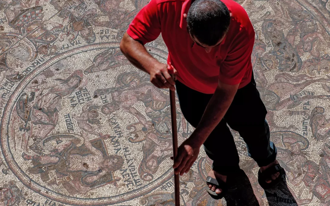 A man is sweeping the mosaic