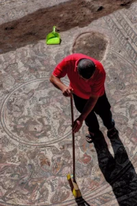A man is sweeping the mosaic
