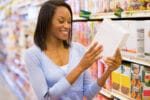 Woman checking food label in supermarket