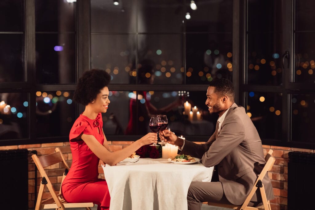Couple Clinking Glasses In Restaurant Could Have Used Baller Button
